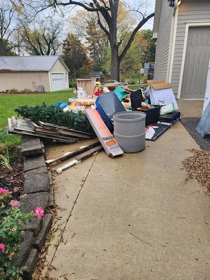 Dumpster being loaded with debris for Estate Cleanout Dumpster Rental in Port Orange